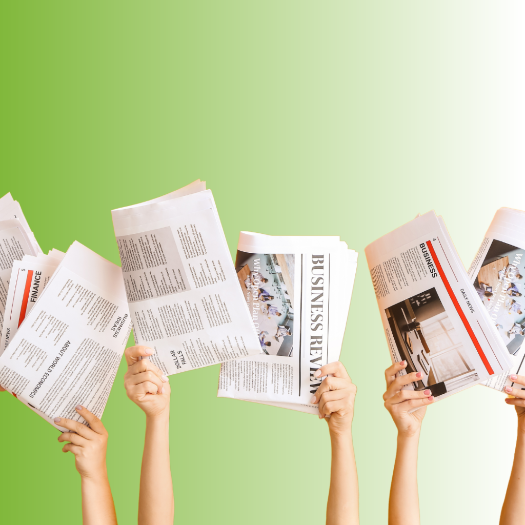 Hands with newspapers on green background