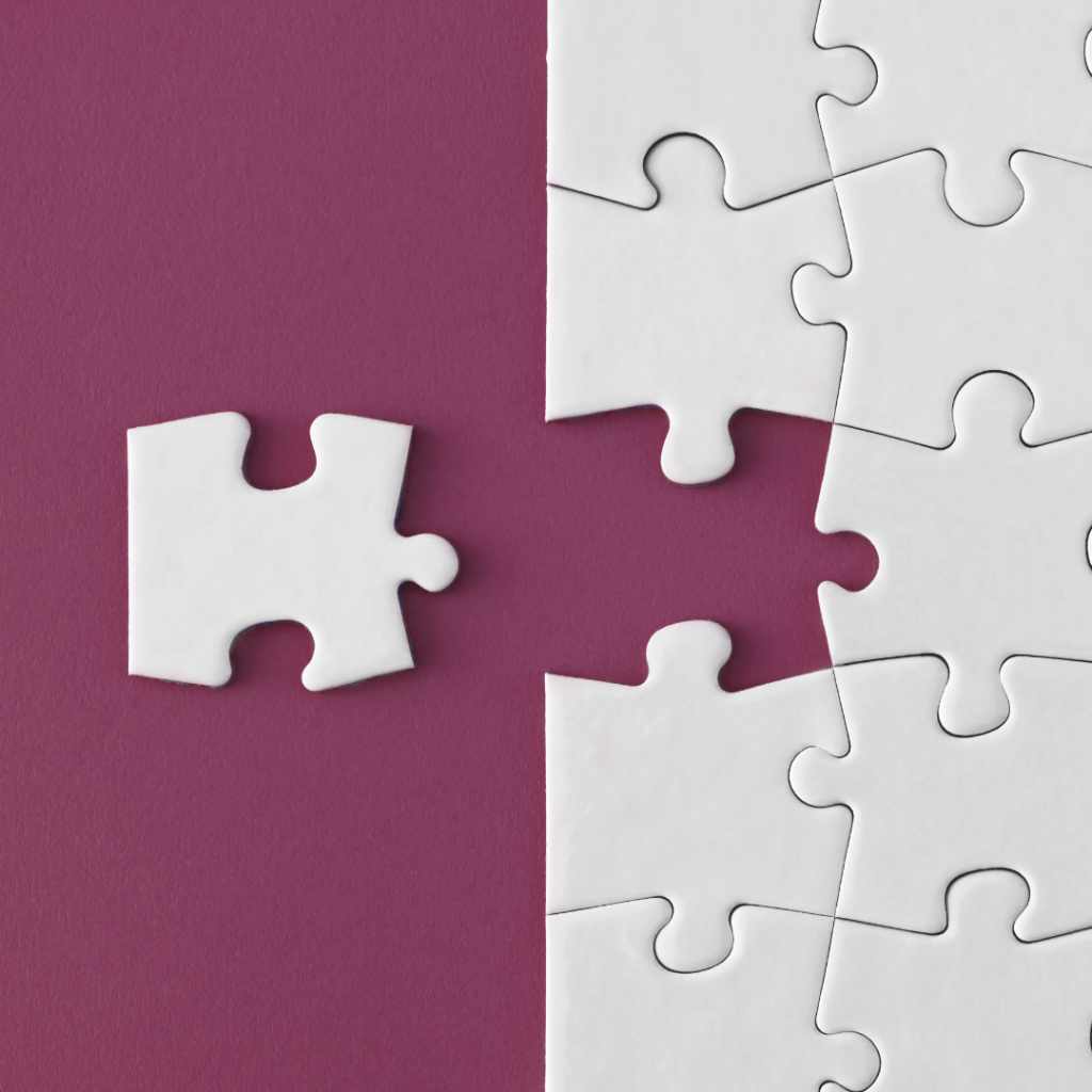 Image of a white puzzle on a maroon background