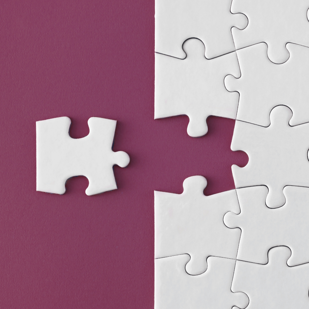 Image of a white puzzle on a maroon background