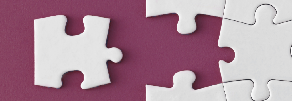 Image of a white puzzle on a maroon background